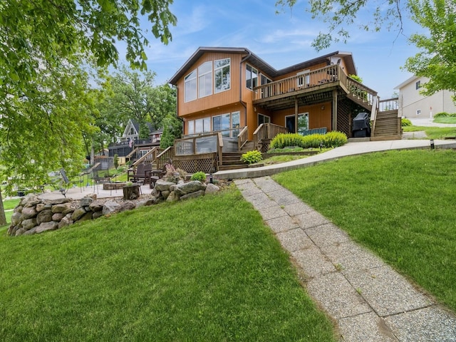 201 Cottage Ln, Montezuma, IA 50171 - back of house with stairs, a wooden deck, a patio area, and a lawn