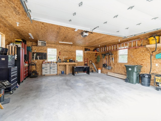 201 Cottage Ln, Montezuma, IA 50171 - garage with a workshop area and a garage door opener
