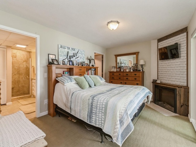 201 Cottage Ln, Montezuma, IA 50171 - carpeted bedroom featuring ensuite bath and a fireplace