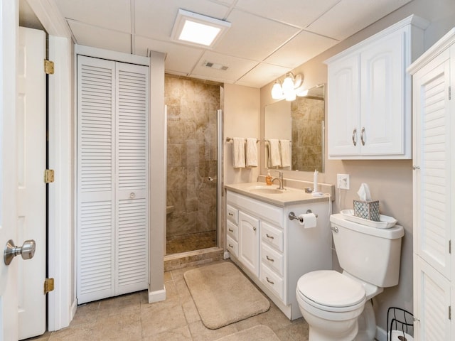 201 Cottage Ln, Montezuma, IA 50171 - full bathroom featuring a closet, vanity, toilet, a drop ceiling, and a stall shower