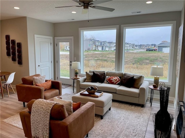 5428 153rd St, Urbandale, IA 50323 - living room featuring a ceiling fan, plenty of natural light, light wood finished floors, recessed lighting, and baseboards