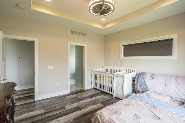 3021 NE 17th St, Ankeny, IA 50021 - bedroom with wood finished floors, recessed lighting, a tray ceiling, and baseboards