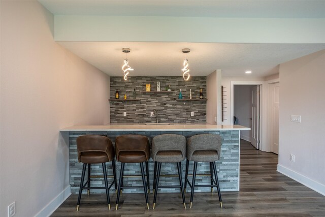 3021 NE 17th St, Ankeny, IA 50021 - indoor wet bar with baseboards, dark wood-type flooring, and pendant lighting