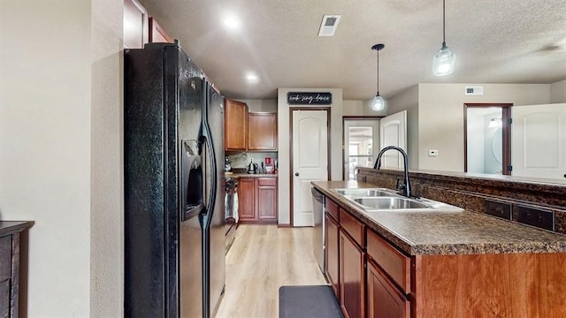 1401 N 6th St Unit 7, Indianola, IA 50125 - kitchen featuring black refrigerator with ice dispenser, a sink, stainless steel dishwasher, dark countertops, and light wood-style floors