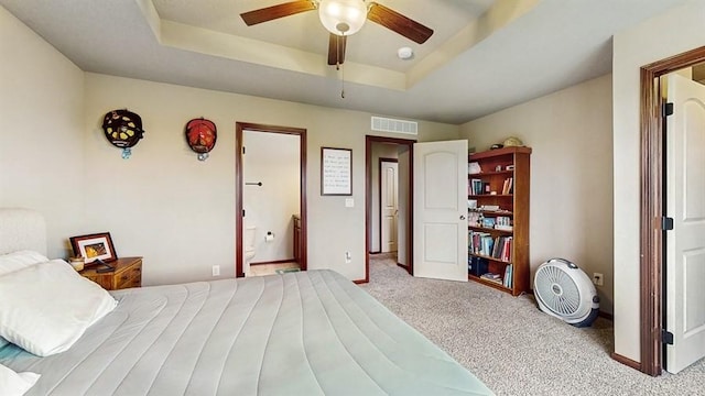 1401 N 6th St Unit 7, Indianola, IA 50125 - carpeted bedroom with a raised ceiling, baseboards, and connected bathroom