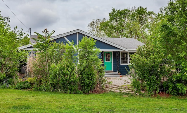 3020 62nd St, Des Moines, IA 50322 - obstructed view of property featuring a front yard, roof with shingles, and entry steps