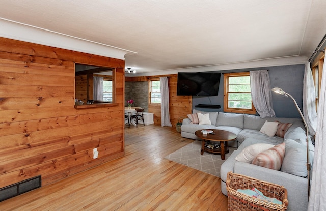 3020 62nd St, Des Moines, IA 50322 - living area with plenty of natural light, wood finished floors, wooden walls, and crown molding