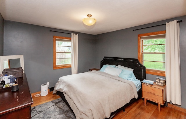3020 62nd St, Des Moines, IA 50322 - bedroom with wood finished floors and multiple windows