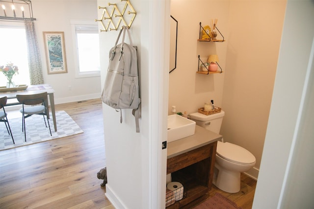 3338 9th Ave SW, Altoona, IA 50009 - half bathroom with toilet, vanity, and wood finished floors