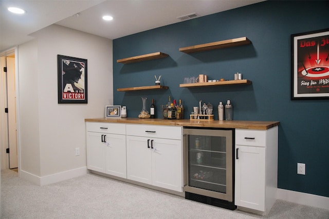 3338 9th Ave SW, Altoona, IA 50009 - indoor dry bar featuring wine cooler, baseboards, light colored carpet, and recessed lighting