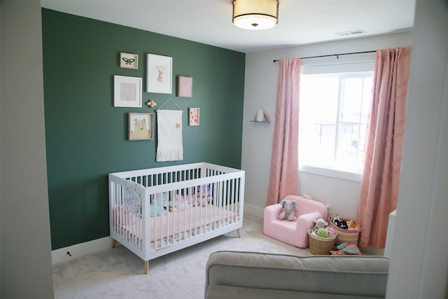 3338 9th Ave SW, Altoona, IA 50009 - bedroom with carpet, a crib, and baseboards