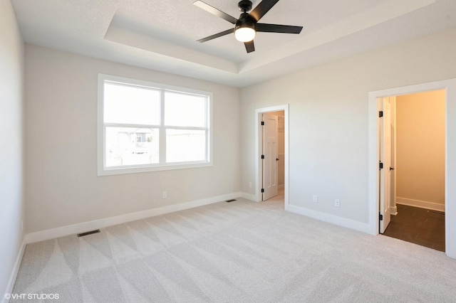 3412 5th Ave SE, Altoona, IA 50009 - unfurnished bedroom with a walk in closet, carpet flooring, a raised ceiling, and baseboards