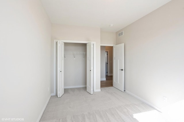 3412 5th Ave SE, Altoona, IA 50009 - unfurnished bedroom featuring light colored carpet, a closet, and baseboards