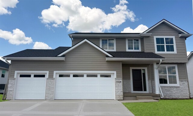 3418 5th Ave SE, Altoona, IA 50009 - view of front of home with stone siding, concrete driveway, and an attached garage