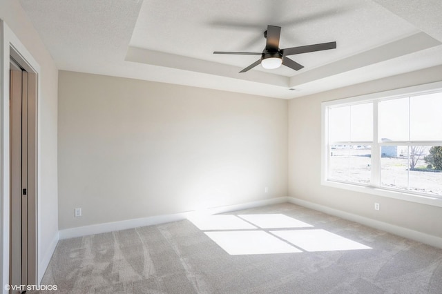 3418 5th Ave SE, Altoona, IA 50009 - unfurnished room featuring a tray ceiling, carpet flooring, a ceiling fan, and baseboards