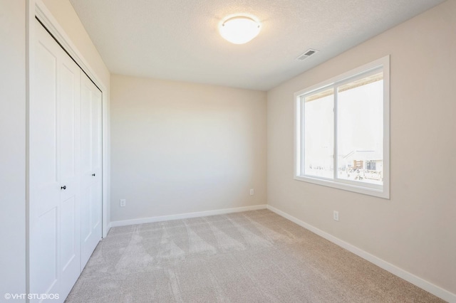 3418 5th Ave SE, Altoona, IA 50009 - unfurnished bedroom with a closet, carpet flooring, and baseboards