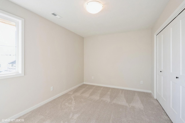 3418 5th Ave SE, Altoona, IA 50009 - unfurnished bedroom featuring light carpet, a closet, and baseboards