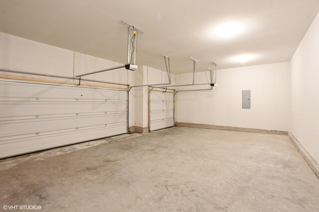3424 5th Ave SE, Altoona, IA 50009 - garage with electric panel, a garage door opener, and baseboards