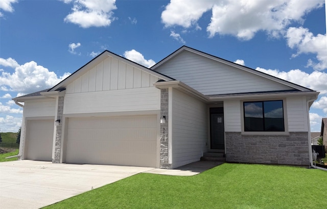 3424 5th Ave SE, Altoona, IA 50009 - ranch-style house with an attached garage, stone siding, a front yard, entry steps, and concrete driveway
