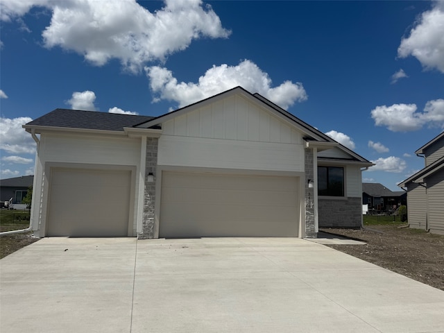 3424 5th Ave SE, Altoona, IA 50009 - single story home featuring a garage, driveway, stone siding, and board and batten siding