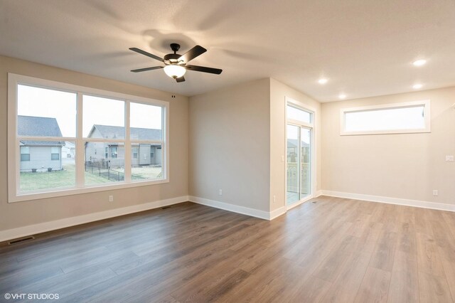 3424 5th Ave SE, Altoona, IA 50009 - spare room featuring wood finished floors, plenty of natural light, ceiling fan, and recessed lighting