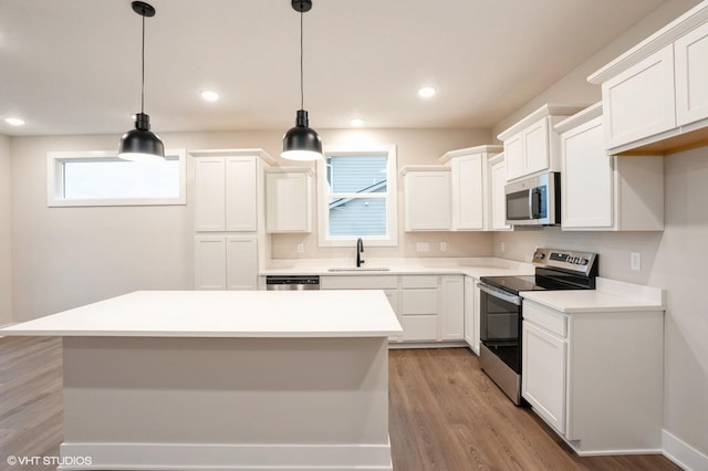 3424 5th Ave SE, Altoona, IA 50009 - kitchen with stainless steel appliances, a sink, light wood finished floors, white cabinets, and light countertops
