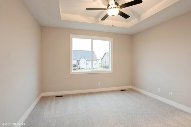 3424 5th Ave SE, Altoona, IA 50009 - unfurnished room with a raised ceiling, carpet floors, a ceiling fan, and baseboards