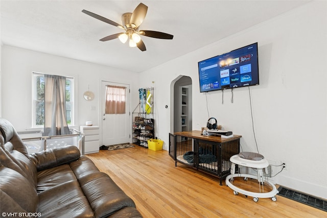 5713 Clark Blvd, Des Moines, IA 50311 - living room with ceiling fan, wood finished floors, and arched walkways