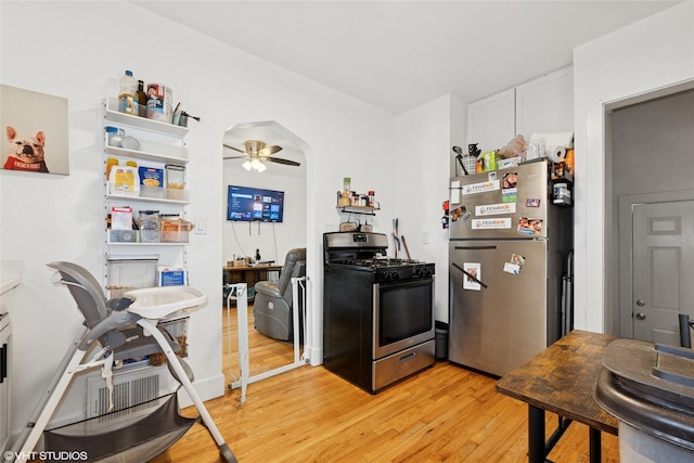 5713 Clark Blvd, Des Moines, IA 50311 - kitchen with appliances with stainless steel finishes, light wood-type flooring, ceiling fan, and white cabinetry