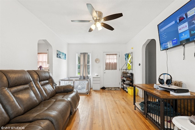 5713 Clark Blvd, Des Moines, IA 50311 - living room featuring arched walkways, a ceiling fan, and light wood-type flooring