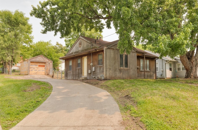2721 Cornell St, Des Moines, IA 50313 - view of front of house featuring concrete driveway, a garage, and an outbuilding