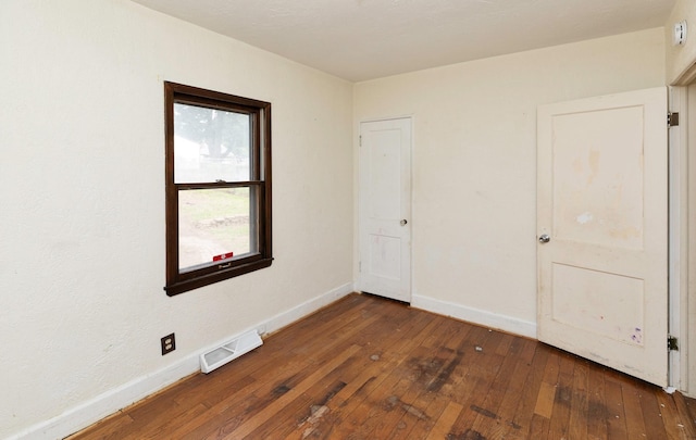2721 Cornell St, Des Moines, IA 50313 - unfurnished bedroom with hardwood / wood-style flooring and baseboards