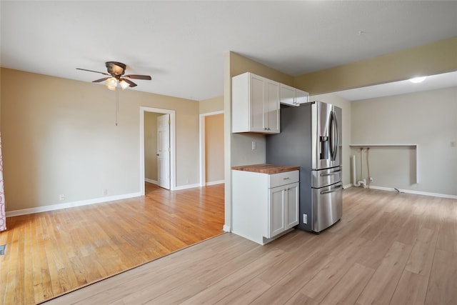 105 N Park Lane Dr, Knoxville, IA 50138 - kitchen featuring stainless steel fridge, wood counters, light wood finished floors, and a ceiling fan