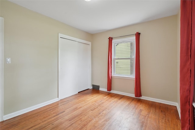 105 N Park Lane Dr, Knoxville, IA 50138 - unfurnished bedroom with light wood-type flooring, a closet, and baseboards