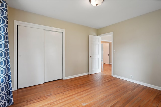 105 N Park Lane Dr, Knoxville, IA 50138 - unfurnished bedroom featuring light wood-type flooring, baseboards, and a closet