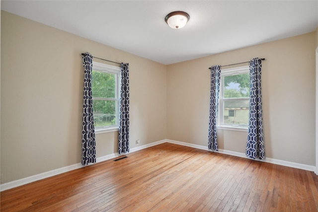 105 N Park Lane Dr, Knoxville, IA 50138 - empty room featuring plenty of natural light, hardwood / wood-style floors, and baseboards