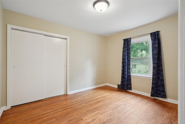 105 N Park Lane Dr, Knoxville, IA 50138 - unfurnished bedroom featuring light wood finished floors, a closet, and baseboards