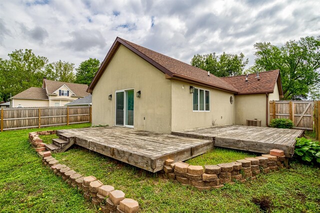 1717 Linn St, Boone, IA 50036 - rear view of property with a deck, stucco siding, and roof with shingles