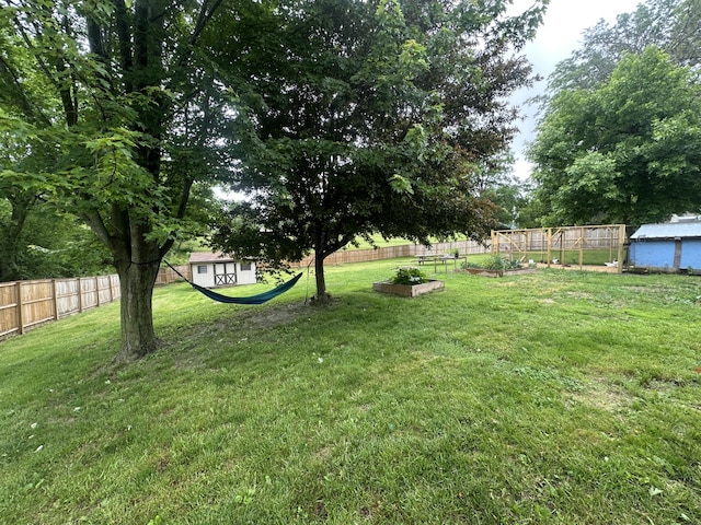 303 S Dewey St, Osceola, IA 50213 - view of yard featuring a garden and an outdoor structure