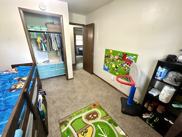 303 S Dewey St, Osceola, IA 50213 - bedroom featuring carpet floors, a closet, and a textured ceiling