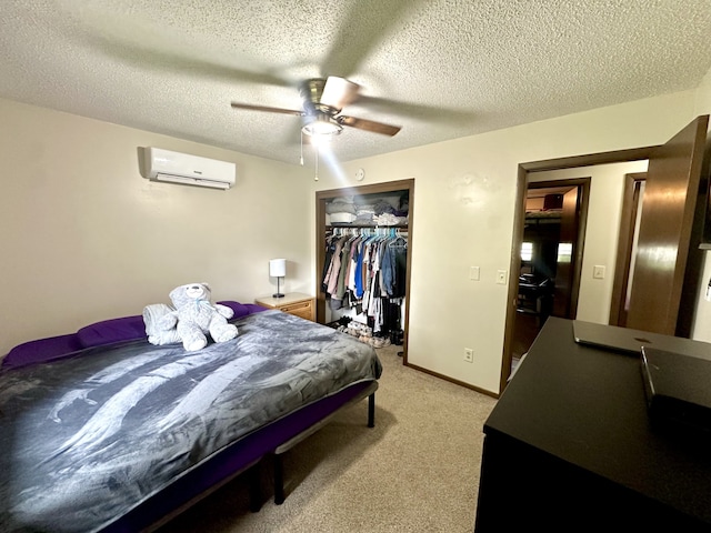 303 S Dewey St, Osceola, IA 50213 - bedroom with a wall mounted AC, a closet, a textured ceiling, light carpet, and a ceiling fan