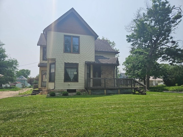 303 S Roche St, Knoxville, IA 50138 - rear view of property featuring a yard, a wooden deck, and stone siding