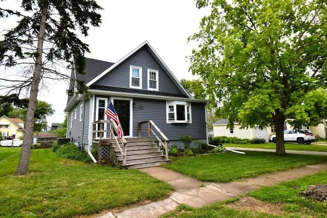 231 S 1st St, Ogden, IA 50212 - bungalow with a front yard and cooling unit