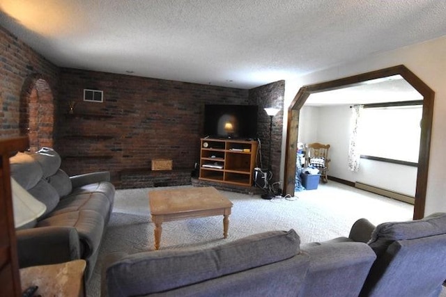 231 S 1st St, Ogden, IA 50212 - carpeted living area featuring a textured ceiling and a baseboard heating unit