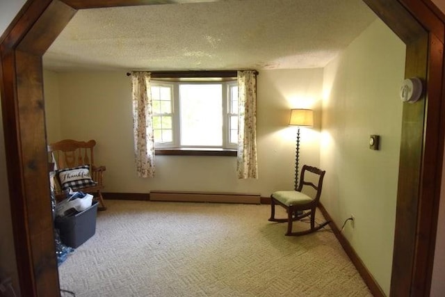 231 S 1st St, Ogden, IA 50212 - unfurnished room with a baseboard heating unit, carpet floors, baseboards, and a textured ceiling
