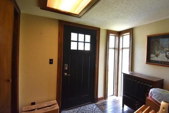231 S 1st St, Ogden, IA 50212 - foyer entrance with wood finished floors and a textured ceiling