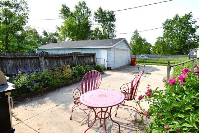 231 S 1st St, Ogden, IA 50212 - view of patio / terrace with a detached garage and an outdoor structure