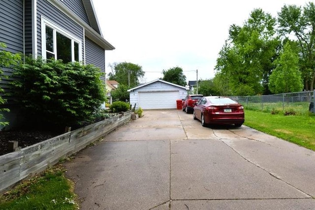 231 S 1st St, Ogden, IA 50212 - view of side of home featuring an outdoor structure and a garage