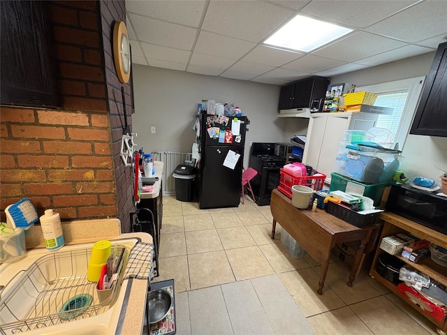 1555 16th St, Des Moines, IA 50314 - kitchen featuring freestanding refrigerator, a paneled ceiling, and light tile patterned floors