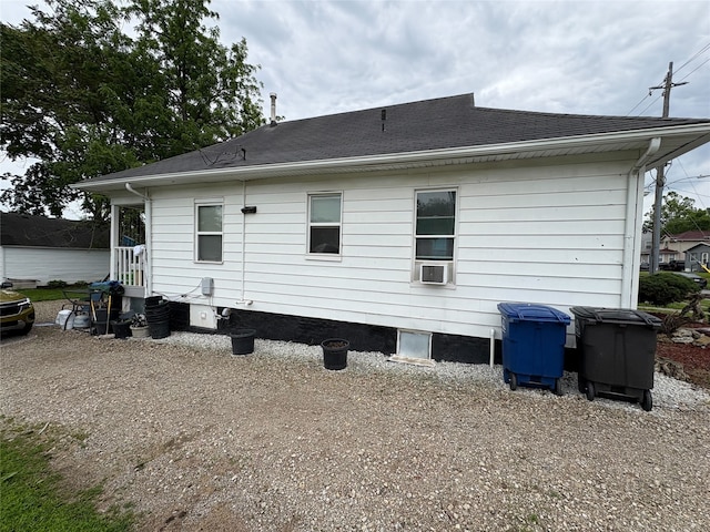 1555 16th St, Des Moines, IA 50314 - back of property featuring a shingled roof and cooling unit